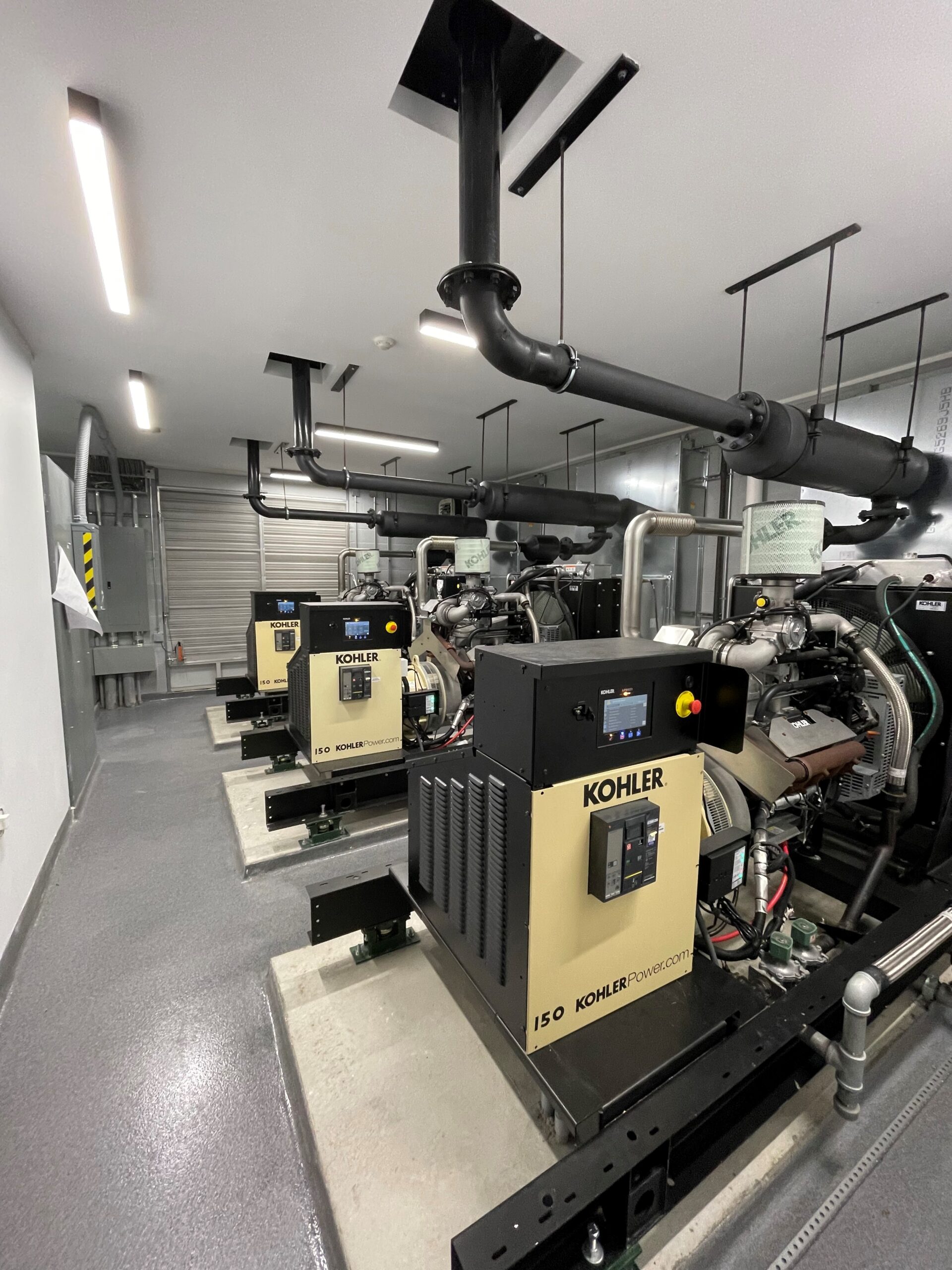 A well-maintained set of commercial Kohler generators in a clean environment, highlighting the importance of keeping the generator clean for efficient performance and reliability.