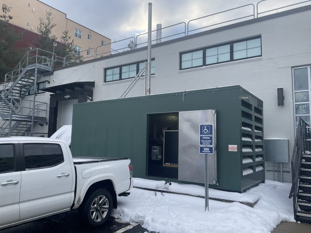 Generator with snow piled up around in and in the vents after a snow storm. If the snow was higher it could block access to the unit. 