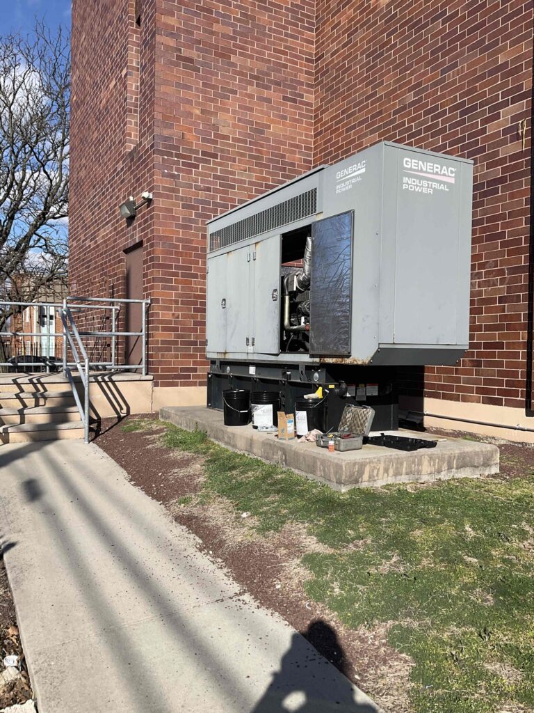 Battery inspection during a monthly generator exercise to ensure reliable startup.