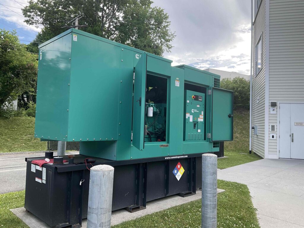 Technician performing a scheduled generator exercise on an industrial generator.