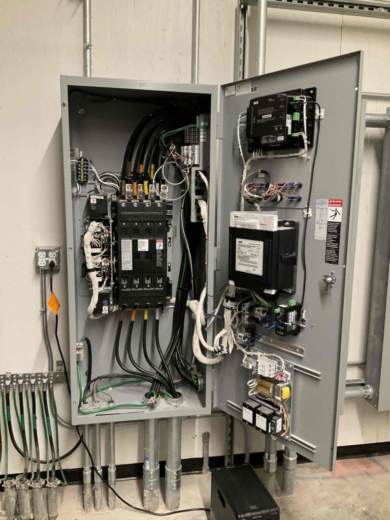 The inside of an automatic transfer switch (ATS) being inspected because a generator was running for no reason