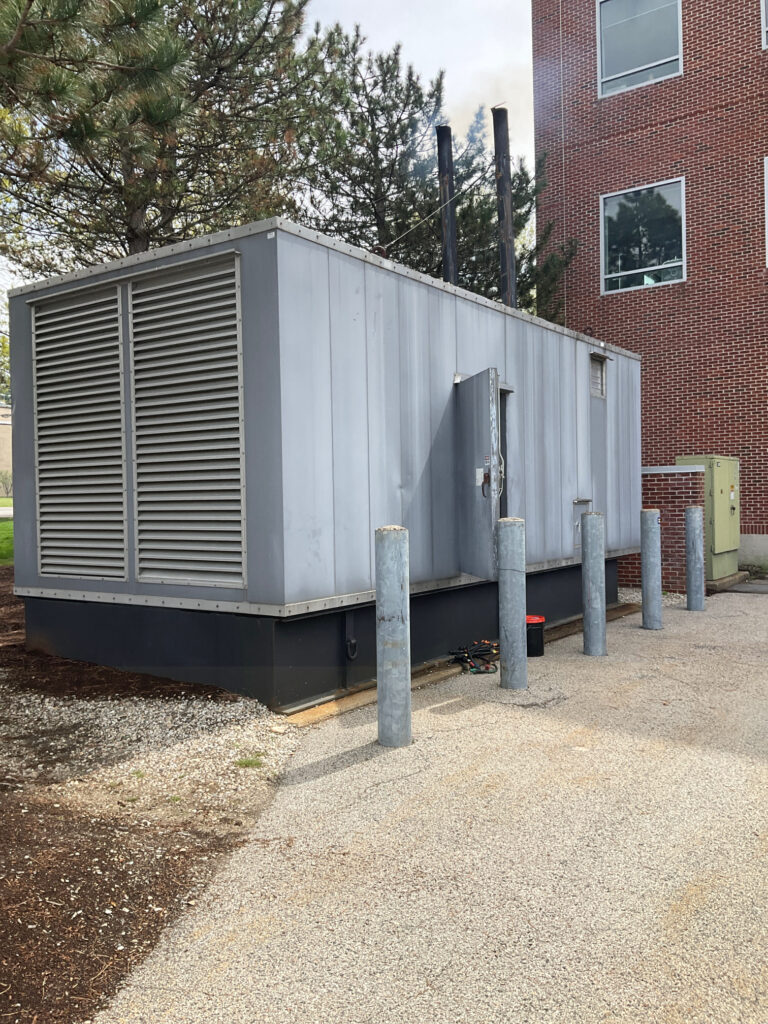 Old backup generator before EPA Tier Ratings were in place being tested. You can see the generator emission coming out of the exhaust pipes.