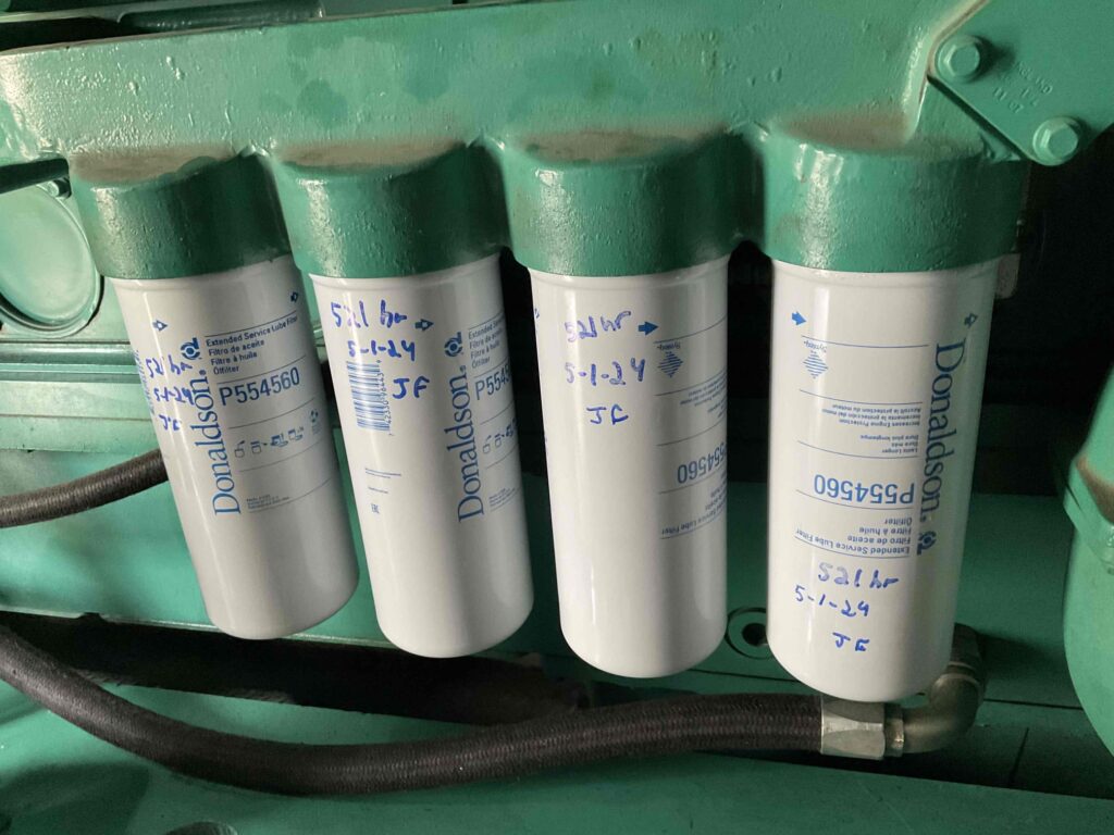 Photo of oil filters on a Cummins generator that are about to be changed as part of a generator maintenance service. 