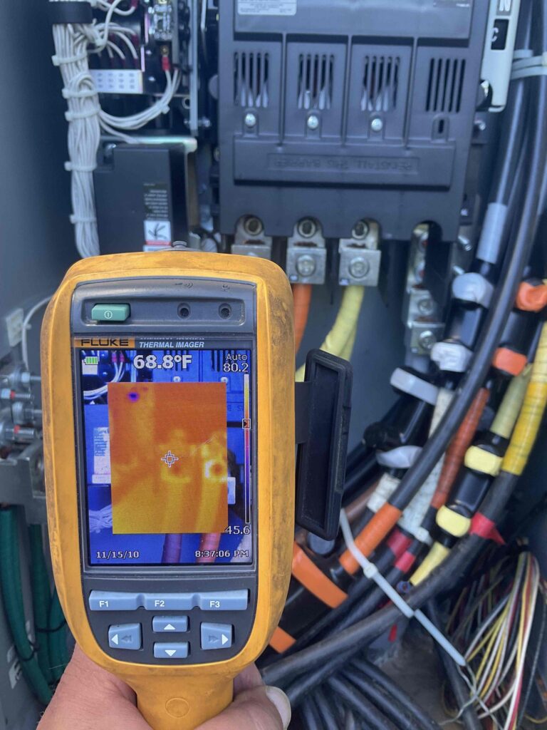Weld Power Generator Technician performing infrared scanning (Thermal Imaging) on an automatic transfer switch (ATS)