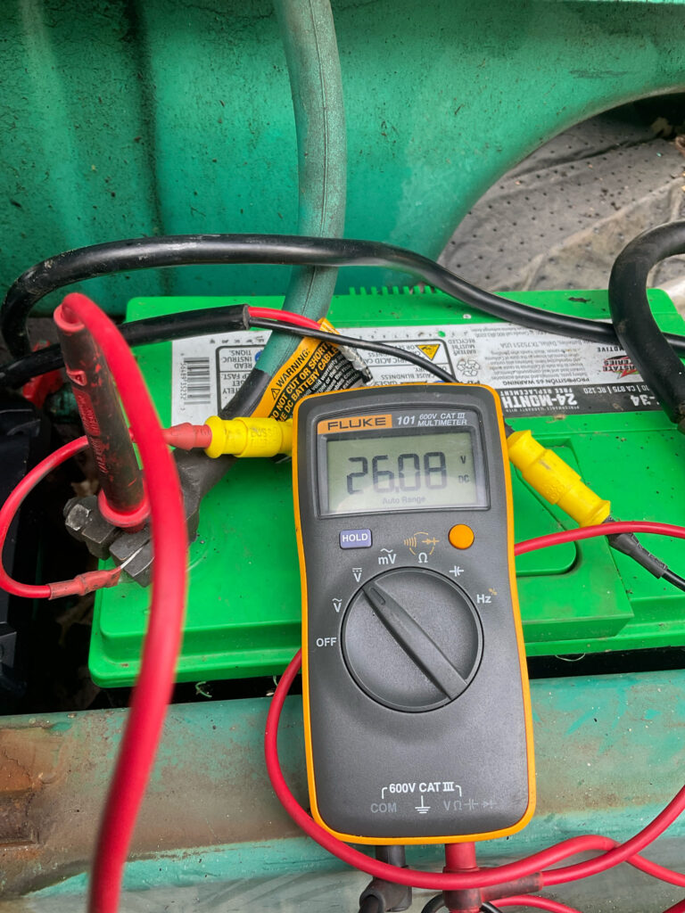Weld Power Generator Technician is testing the generator battery voltage as part of the generator maintenance service
