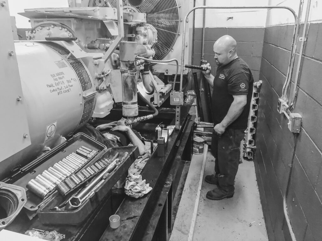 Weld Power generator technician performing preventative maintenance on a generator